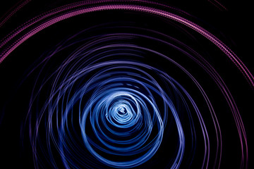 Colorful abstract trails of light. Dots, lines and bokeh on dark background. Long exposure.