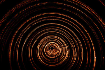 Colorful abstract trails of light. Dots, lines and bokeh on dark background. Long exposure.