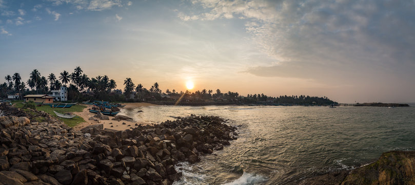 Beautiful sunrise at the Indian Ocean coast on Kumarakanda Fishery Harbor in Sri Lanka