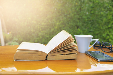 Stock Photo:.Composition with books and cup of coffee on the tab