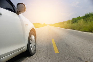 Stock Photo:.Close up side of white car and light on the road