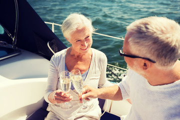 senior couple clinking glasses on boat or yacht