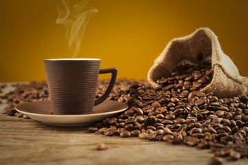 Turkish coffee with beans on brown background