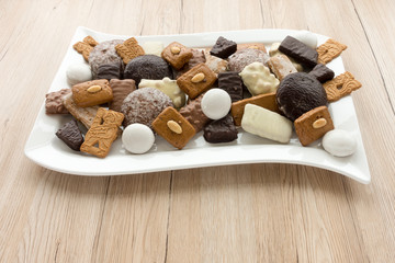 Large Assortment of German Gingerbread, Aachener Printen, Lebkuchen, Spitzkuchen, Spekulatius and Pfeffernuesse.
On brown wooden background with copy space.