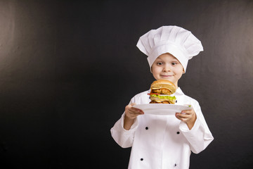 funny boy chef cooked hamburger