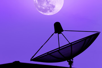 Communication satellite dish on the roof with supermoon sky back
