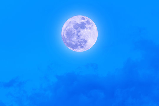 Supermoon with blue sky and clouds.
