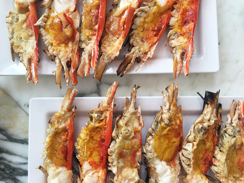 Cutting half shrimp burn sea food on dish.