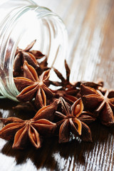 Star anise, glass jar on dark wood table