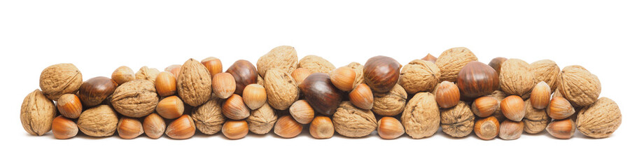 Walnuts, hazelnuts and chestnuts stacked on top - isolated on white backdrop