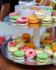 Colorful macaron cookies on bar for sale