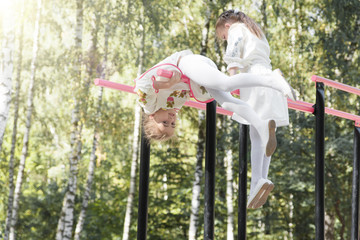 two little girls in traditional Ukrainian dress playing in the p