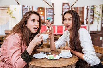 Astonished girls in coats