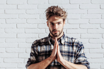 Calm man with palms together