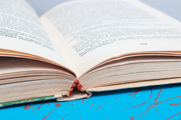 Fototapeta premium open book lying on a wooden table