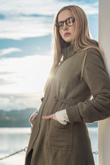 Young girl in a coat and glasses