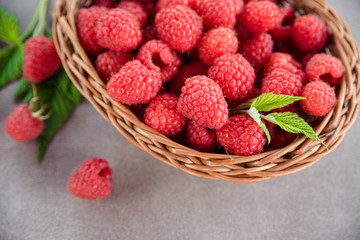 Fresh summer raspberry in a basket. Selective focus.