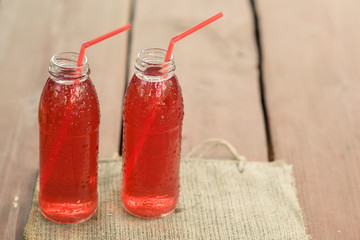 Two bottles of cold stewed fruit from assorted berries.