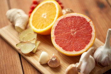 grapefruit, ginger, garlic and orange on board