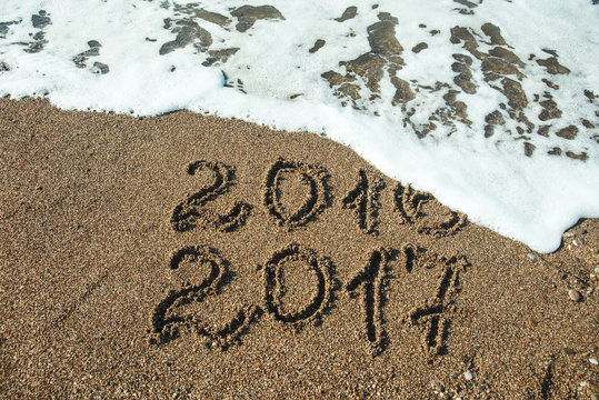 Numbers 2017 on beach. New year holiday concept .
