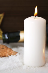 Happy new year card with candles and bottle of champagne on snow