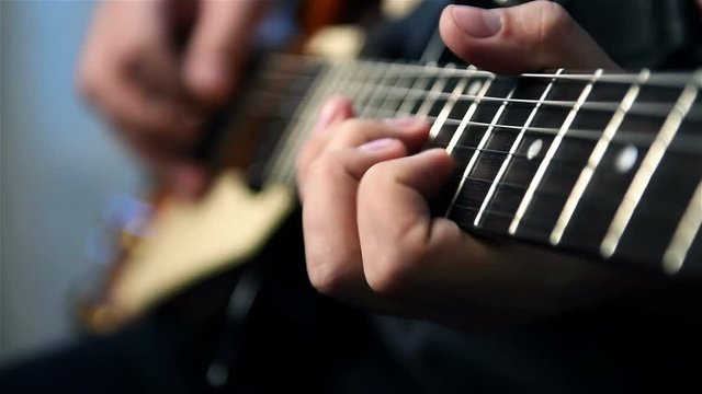 Professional Guitarist Playing Rock Solos An Electric Guitar