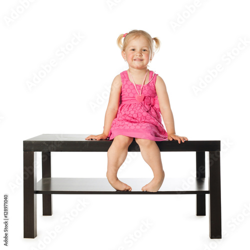 "little girl on the table isolated" photo libre de droits sur la banque