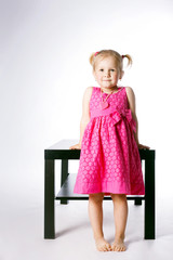 cute little girl sitting on table