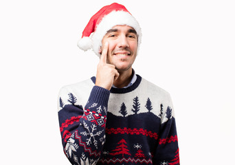 Happy young man with a gesture of observe at Christmas