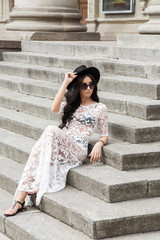 girl walking down the street in a transparent white dress