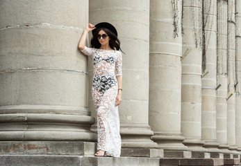 girl walking down the street in a transparent white dress