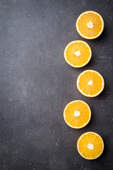 Fresh oranges on dark stone table. Top view