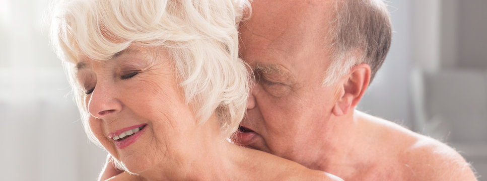 Elderly naked woman kissing with passion