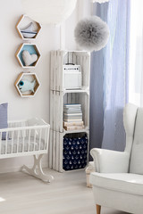 Neutral nursery with cradle and chair
