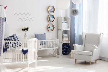 Nursery with white chair and cradle