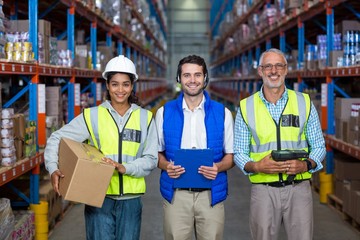 Portrait of warehouse workers standing together