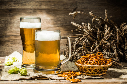 Mug, glass of beer on wooden table