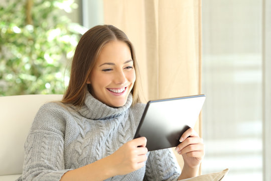 Girl Using A Tablet At Home In Winter