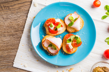 Bruschetta with tomato, cheese and bacon