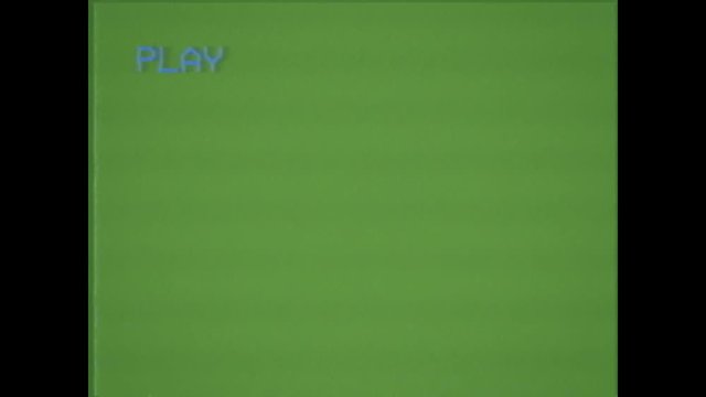 An old damaged VHS tape playing, green screen with PLAY text. A vintage background for videos, a retro element.
