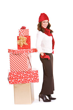Christmas: Winter Woman Standying By Stack of Gifts