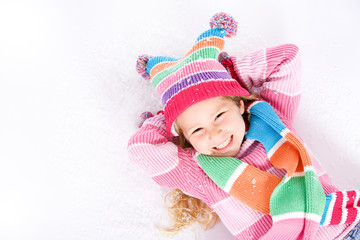 Winter: Laughing Little Girl Lying In Snow