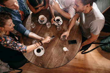 Young people looking at pictures on smart phone