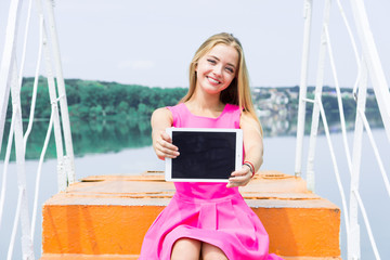 woman showing tablet screen