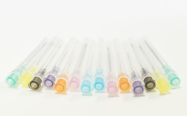 Colorful Needles put in needle sheath sort on white background.