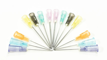 Colorful Needles put in needle sheath sort on white background.