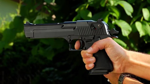 slow motion of a young person shooting with airsoft gun replica