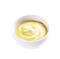 Creamy sauce, salad in ceramic cup on white background