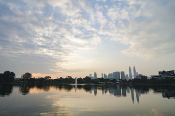 Fototapeta na wymiar Kuala Lumpur City with reflection on the lake and dramatic cloud