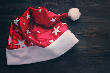 Santa red hat on wooden background close up